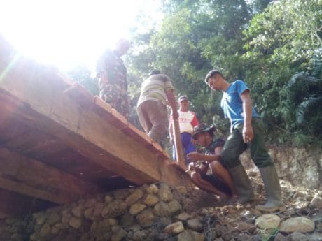 Personil Satgas TMMD 104 Angkat Papan Untuk Pembuatan Jembatan Dibawah Terik Matahari.