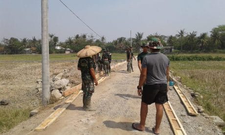 Hindari Sengatan Matahari Satgas TMMD Kronjo Pakai Caping