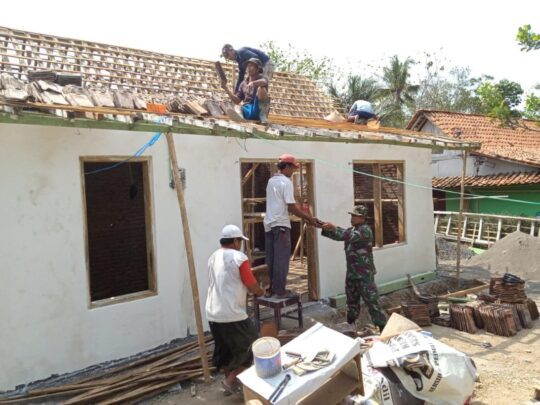 Satgas TMMD bersama Warga Dusun Kalirau Bantu Naikkan Genteng Rumah Salam