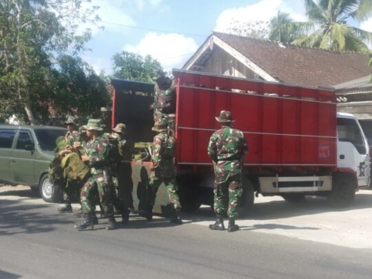 Truk Merah Pengagkut Personel Satgas TMMD