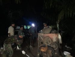 Menunggu Hujan Reda, Anggota Satgas TMMD Ke-111 Kodim 1207/Pontianak Semangat Bekerja Hingga Malam Hari