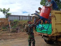 Anggota Satgas TMMD Bersama Warga Turunkan Tempat Cuci Tangan