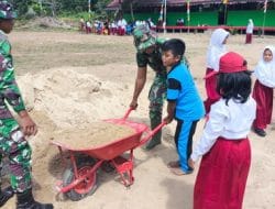 Anak-Anak Satgas TMMD Membantu Pemindahan Pasir untuk Pengecoran Tiang Sumur Bor di SDN 1 Manyahi
